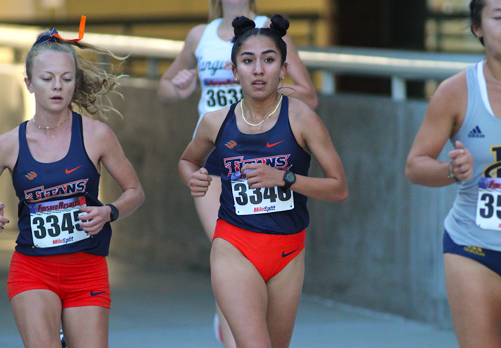 Emily Olson and Olivia Ruiz running side by side