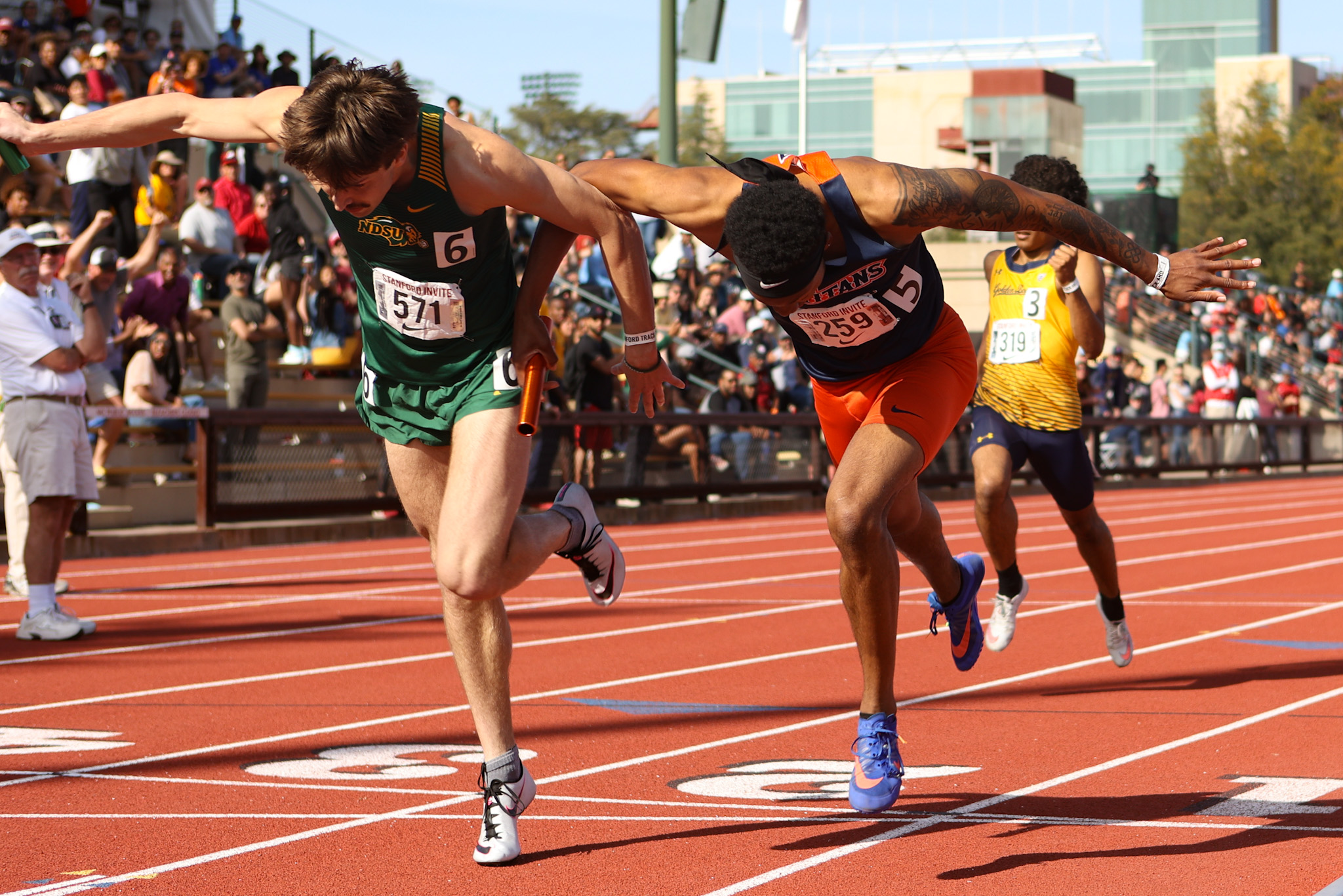 Charles Kelly crossing the line of the 4x400m. Photo by Jayce Smith.