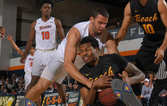 Dominik Heinzl wrestling with an LBSU player for a loose ball
